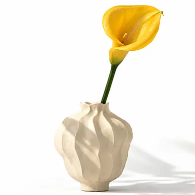 A bouquet of flowers in minimalism style in a modern vase Jamie Young Poppy in yellow color with a Calla branch, Calla. Set 846.